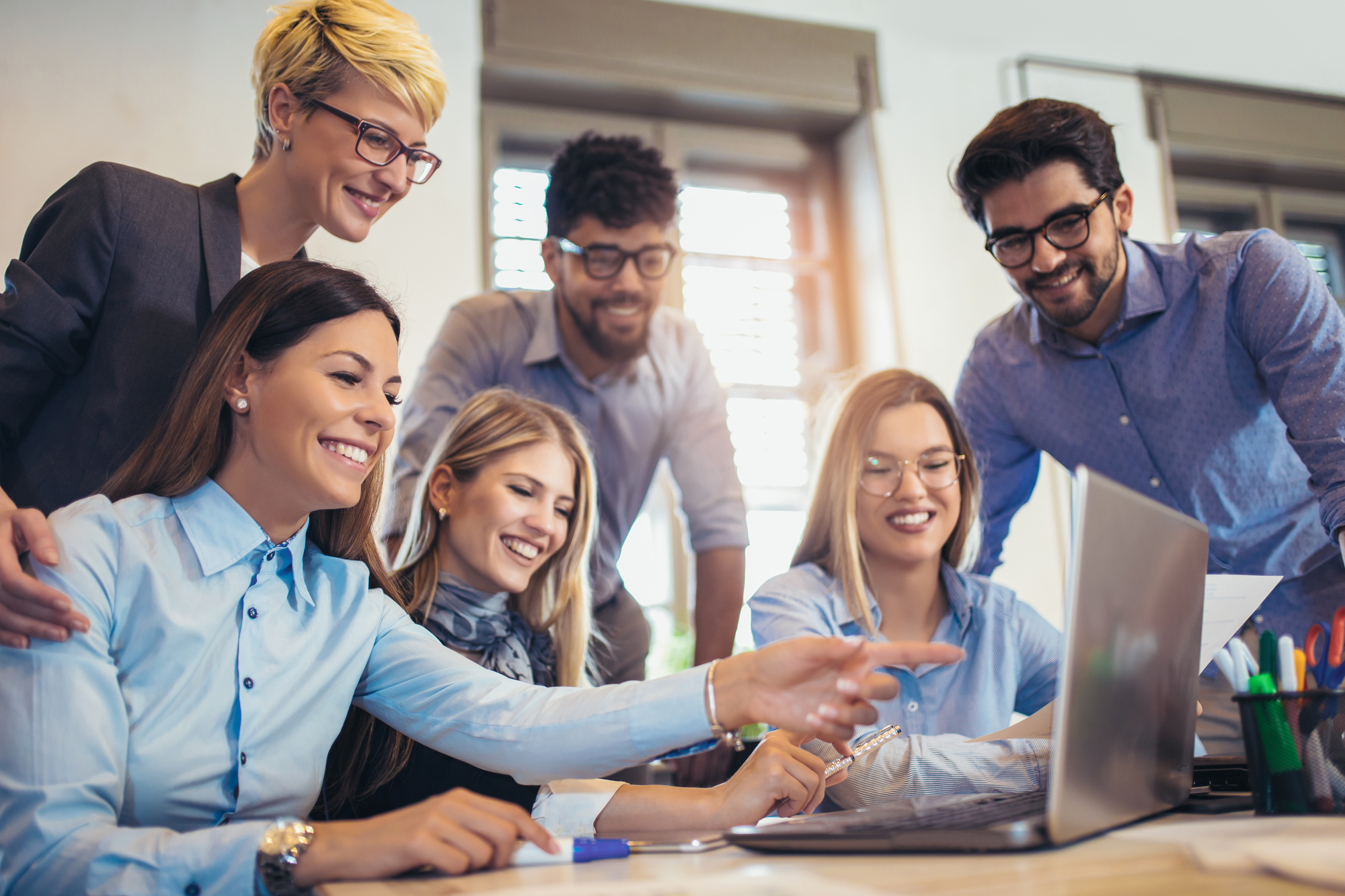  Group of young business people in smart casual wear working together in creative office