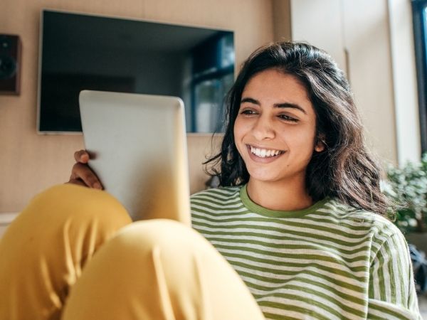 A smiling girl with a tablet